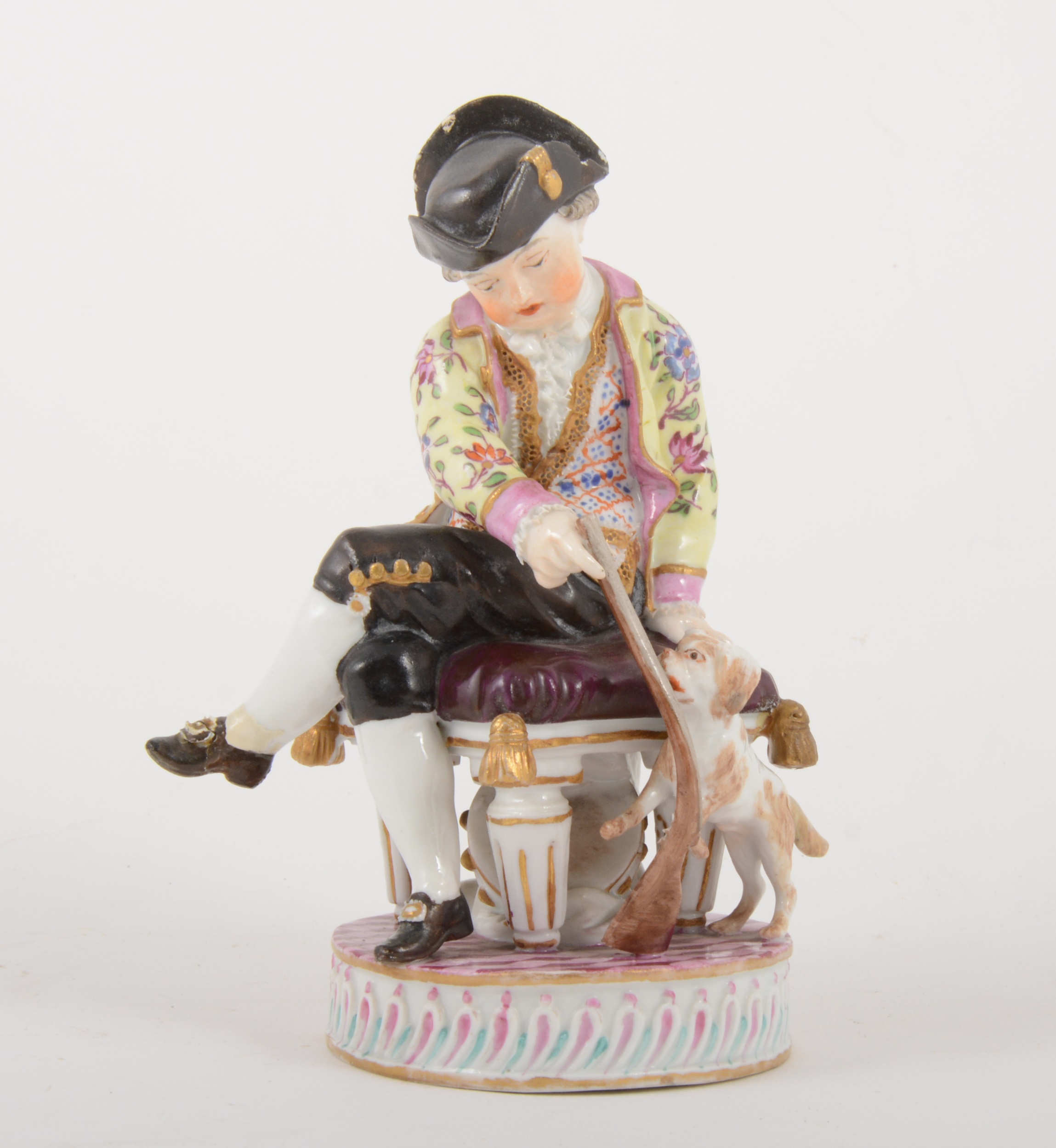 A Meissen porcelain figure of a boy with a puppy