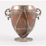 A white metal mounted coconut cup of ovoid form, pricked date 1590