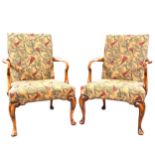 A pair of Georgian style walnut elbow chairs