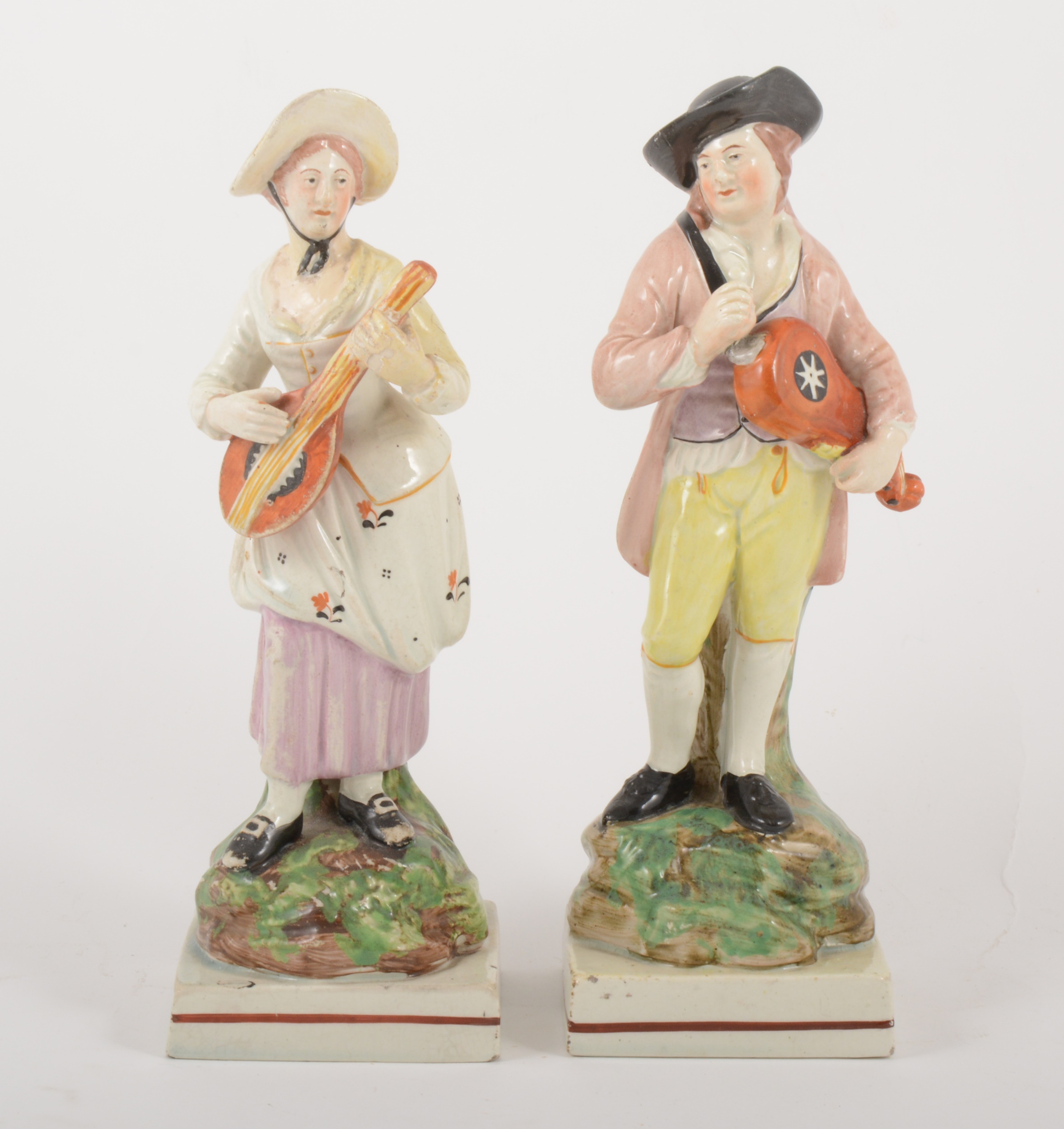 A pair of Staffordshire pearl glazed earthenware figurines