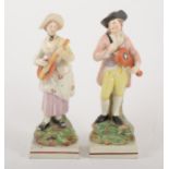 A pair of Staffordshire pearl glazed earthenware figurines
