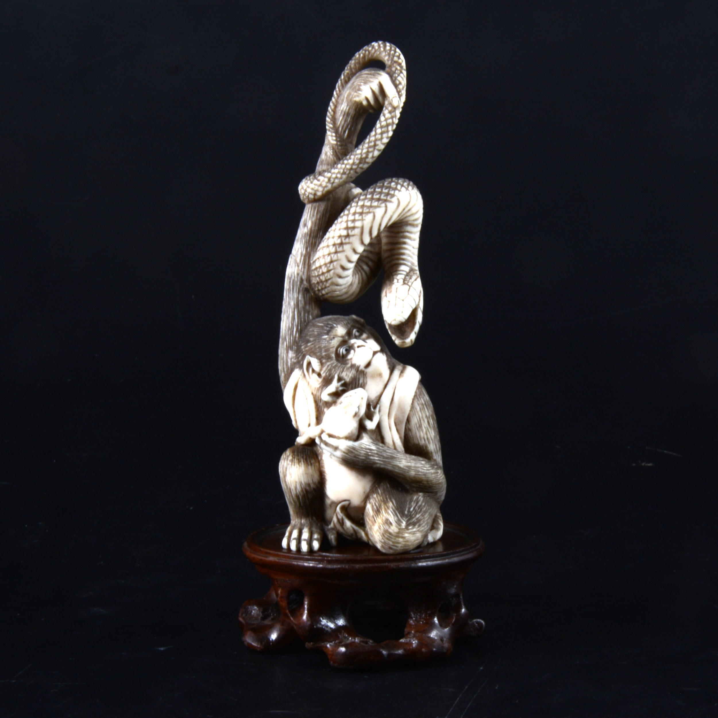A Japanese carved and stained ivory group, early 20th Century