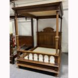 A French walnut four-poster bed