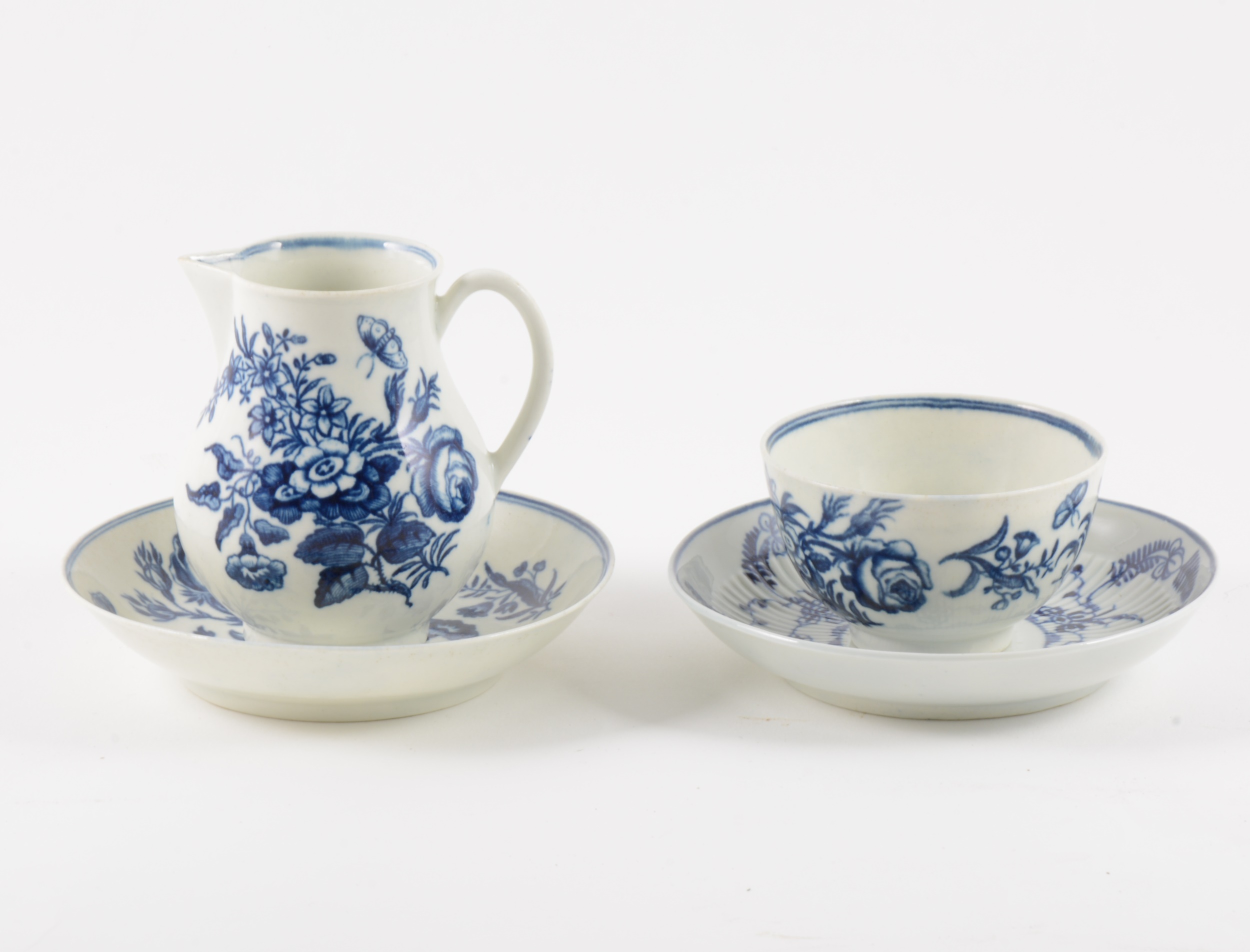 A Worcester blue and white porcelain sparrow-beak jug, matching teabowl and saucer, and another