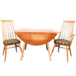 An elm and beech drop-leaf table and four chairs by Ercol