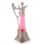 An Art Nouveau pewter and cranberry glass claret jug, by WMF