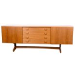 A mid-century teak dining suite