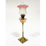 A brass and copper oil lamp, by W. A. S. Benson