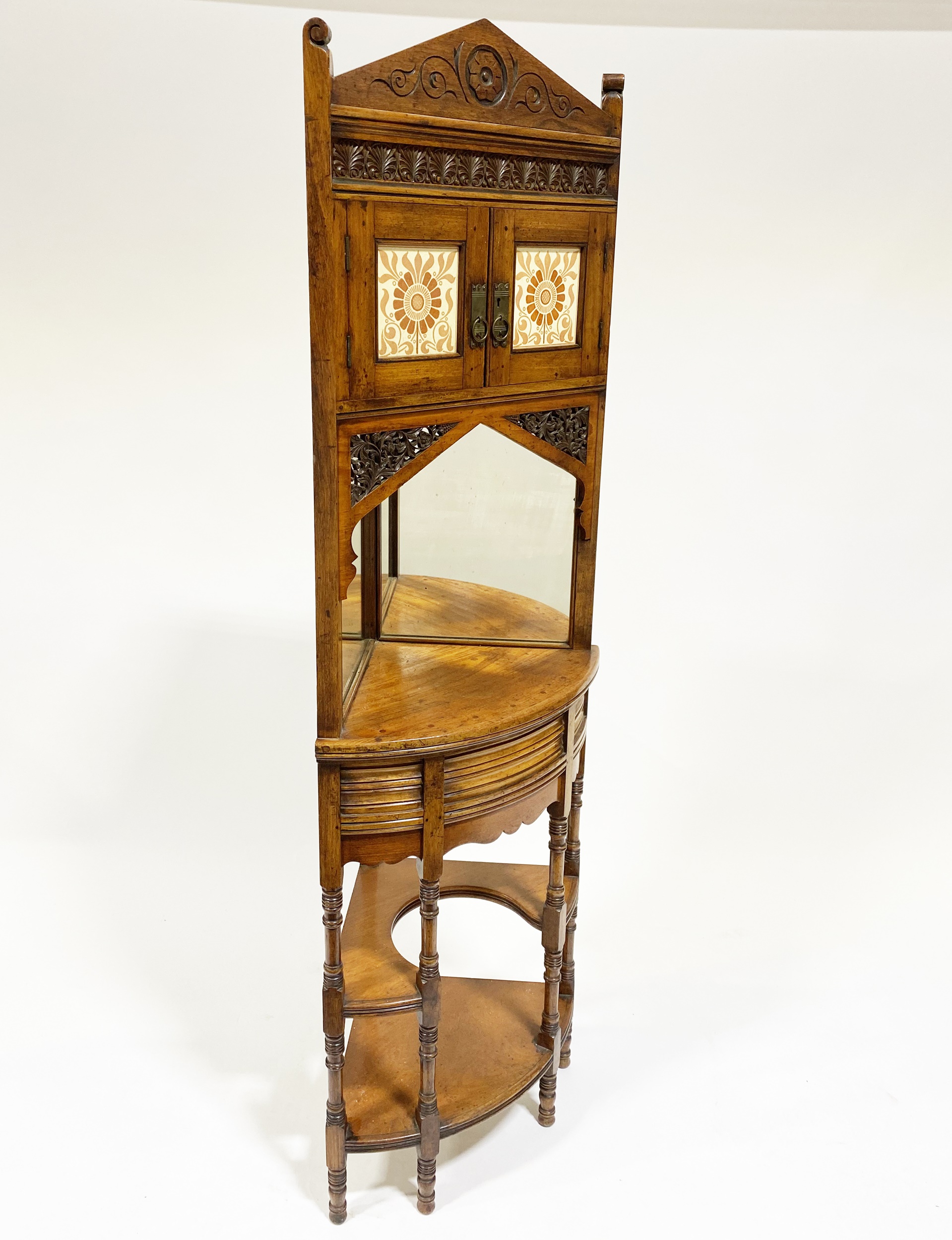 An Indian hardwood and tiled corner cabinet in the Gothic Revival taste