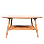 An elm and beech oval coffee table by Ercol