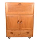 An elm serving cabinet by Ercol, model 430