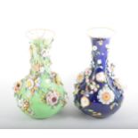 Pair of Continental porcelain vases, bottle shape with flared rims, each profusely encrusted with