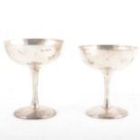 A pair of silver champagne coupes