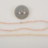 A cultured pearl necklace and another pearl necklace with matching earrings.
