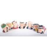 Twelve Royal Doulton character jugs.