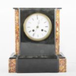 A twin train black slate mantel clock with inlaid coloured marble panels.