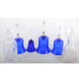 Four blue glass hand bells, 28cm and smaller;