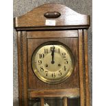 An oak cased wall clock,