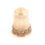 A gilt metal thimble, filigree floral border, in fitted case