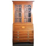 An Edwardian inlaid mahogany bureau bookcase