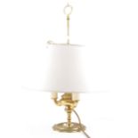 A brass lamp with telescopic adjustable shade.