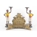 A pair of cast metal and cold painted Blackamoor candlesticks, 27cm;
