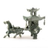 A green and white hard stone carving of a horse pulling an elderly man in a pagoda carriage.