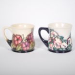 Two Moorcroft Pottery mugs, dated 2003 and 2005