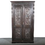 A carved oak two door wardrobe,