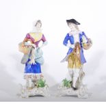 Pair of Continental porcelain figures, with game and flower baskets, 20cm.