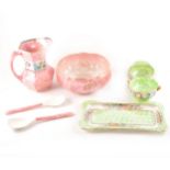 A collection of Maling lustre pottery, including a pair of pink ground bowl