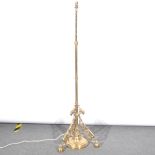 A brass standard lamp, converted to electricity, adjustable column, scrolle