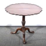 A Georgian mahogany tripod table, tilt-top with shaped and moulded outline,