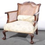 A bergere armchair, upholstered seat, carved walnut frame, width 68cm, dept