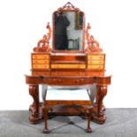 A Victorian mahogany dressing table, stepped arched plate below a carved an