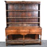 An oak dresser, late 18th Century panelled back with moulded cornice and th
