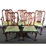 A mahogany dining table and matching set of eight chairs in the Chippendale