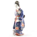 A Japanese porcelain Geisha figurine, in blue floral kimono with a kitten a
