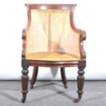 A Victorian easy chair, scroll cresting and arms, with cane panel, bowfront