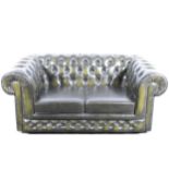 A modern two-seater leather settee in the Chesterfield style, buttoned and