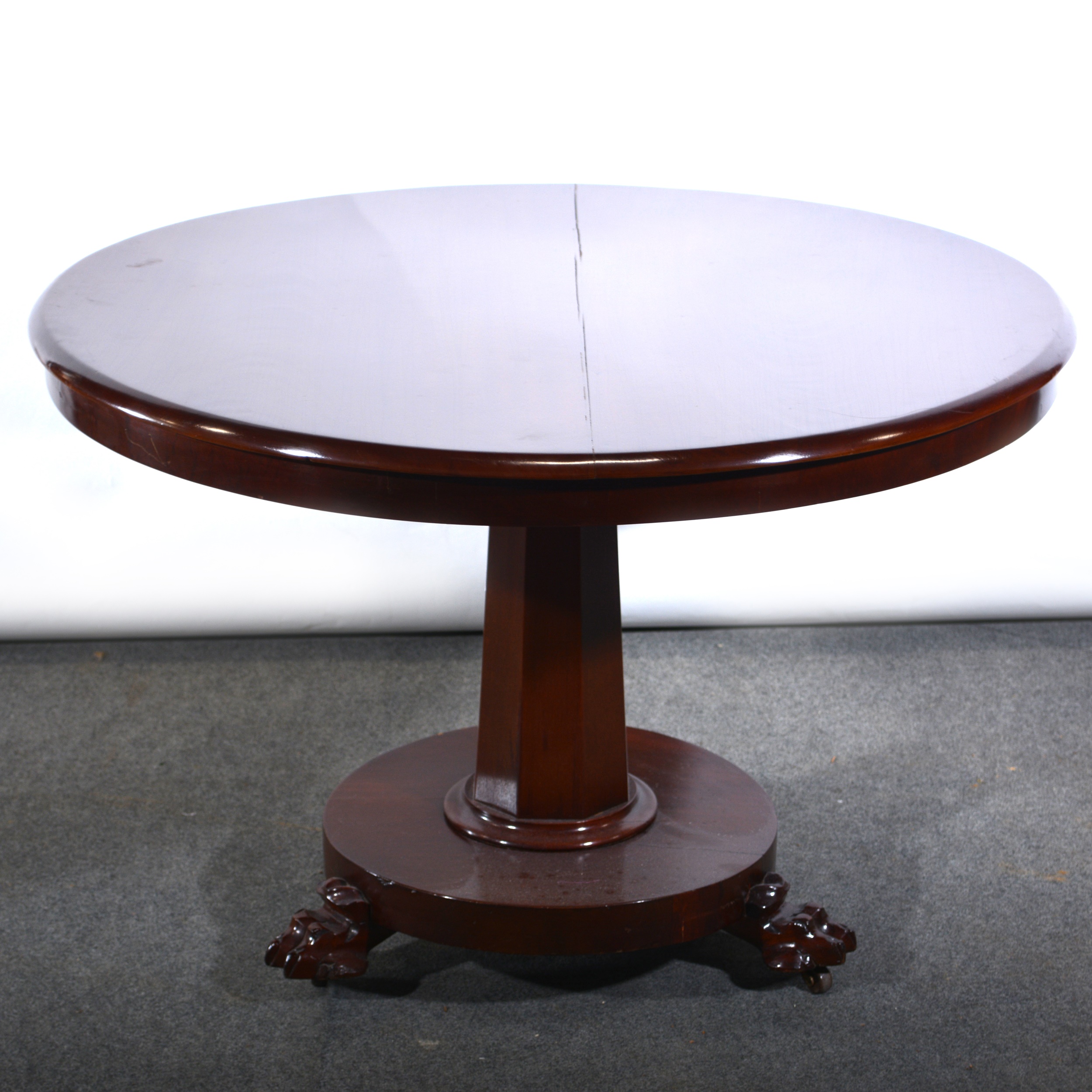 A refinished mahogany breakfast table, circular tilt top, octagonal taperin