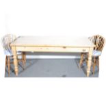 A pine kitchen table, and six beechwood wheel-back kitchen chairs, the tabl