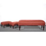 A contemporary upholstered longstool and two matching footstools, stained w