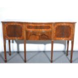 A reproduction mahogany and satinwood serpentine sideboard, two central dra