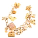 A 9 carat yellow gold charm bracelet with sixteen charms, the alternating l