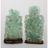 Two Chinese green quartz covered jars, each carved in high relief with bran