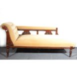 An Edwardian chaise longue, carved and stained walnut frame, length 160cm,