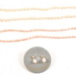A cultured pearl necklace and another pearl necklace with matching earrings