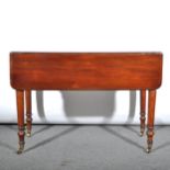 A mahogany Pembroke table, single frieze drawer, turned supports on casters