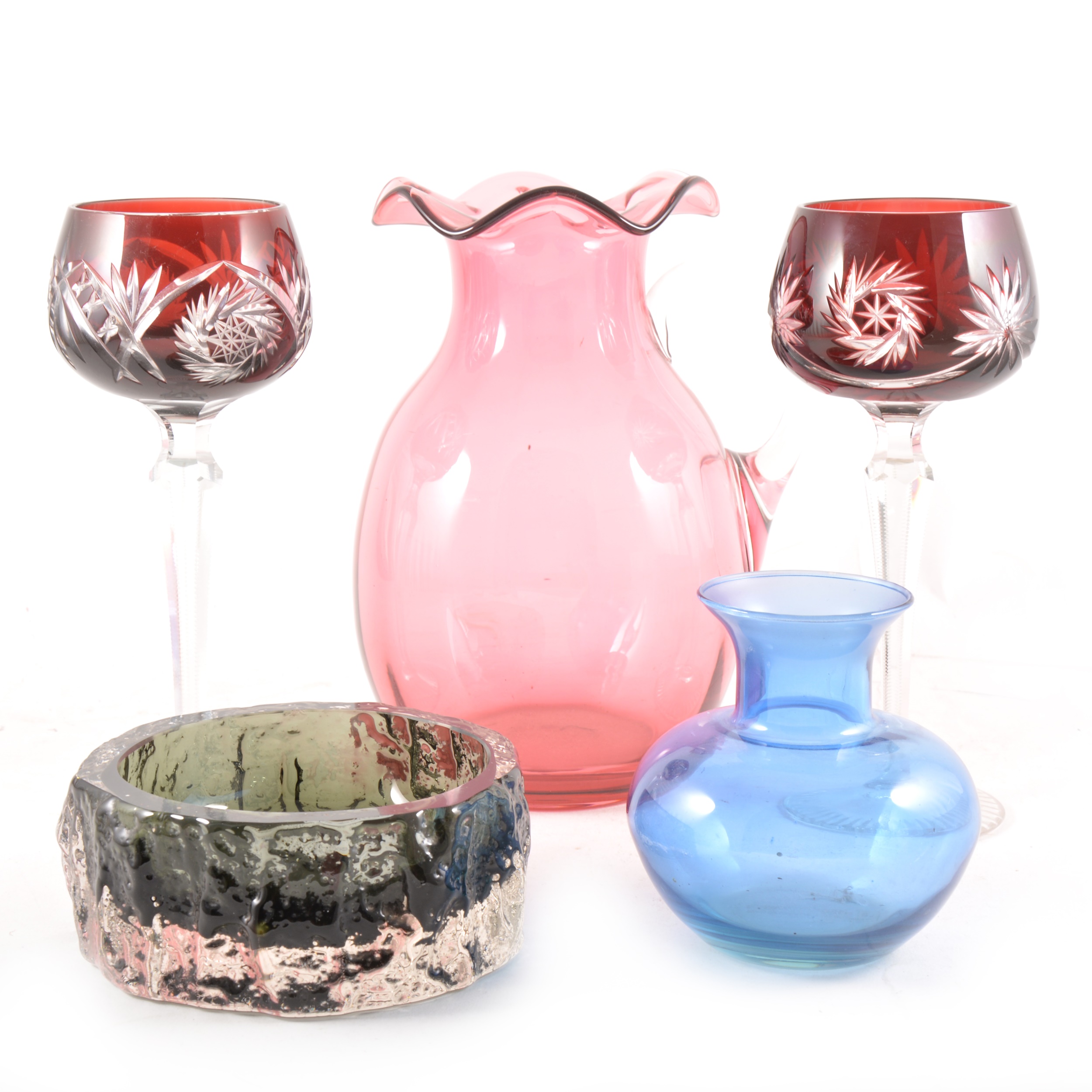 A collection of coloured glassware, including a cranberry jug, 20cm; and a